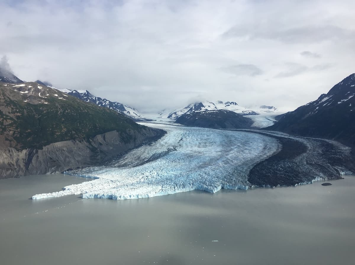 A glacier winds through the mountains